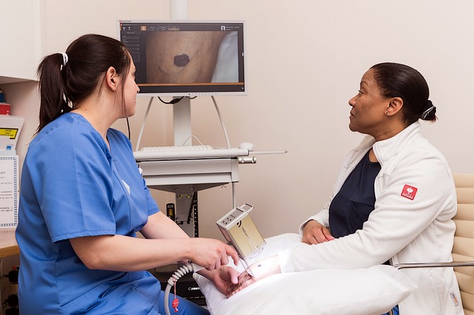 Dermatology staff at London clinic treating patient with dark skin