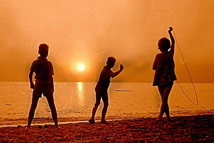 Children on beach at sunset