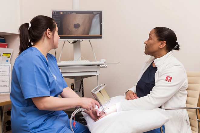 Dermatology nurse using digital microscope